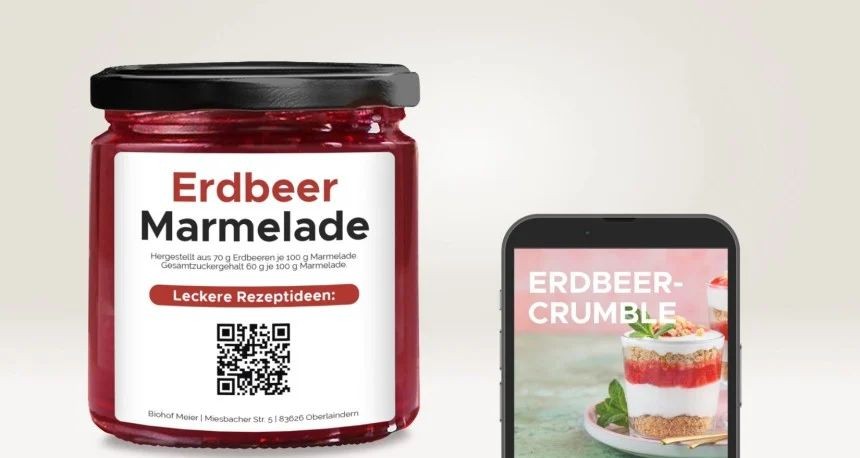Slika prikazuje lonček z doma narejeno marmelado in telefon.