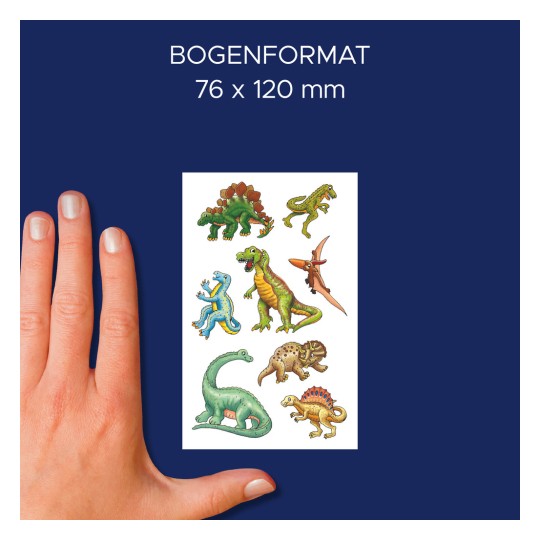 Slika prikazuje roko, ki drži list dinozavrskih nalepk z različnimi dizajni dinozavrov na temno modrem ozadju. Velikost lista je navedena kot 76 x 120 mm.