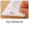 Slika prikazuje roko, ki odlepi nalepko z kartonskega paketa, pri čemer so vidni naslov za pošiljanje in črtna koda. Pod sliko je prikazan tekst 'Top Klebkraft', kar nakazuje na močno lepilno kakovost.