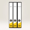 The image displays three black binders labeled 'BÜRO', 'KUNDEN', and 'PROJEKTE' with a yellow design at the bottom.
