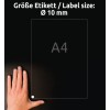 Slika prikazuje roko pod listom formata A4 z označeno velikostjo nalepke Ø 10 mm. Ozadje je temno, besedilo pa je v nemščini in navaja velikost nalepke.